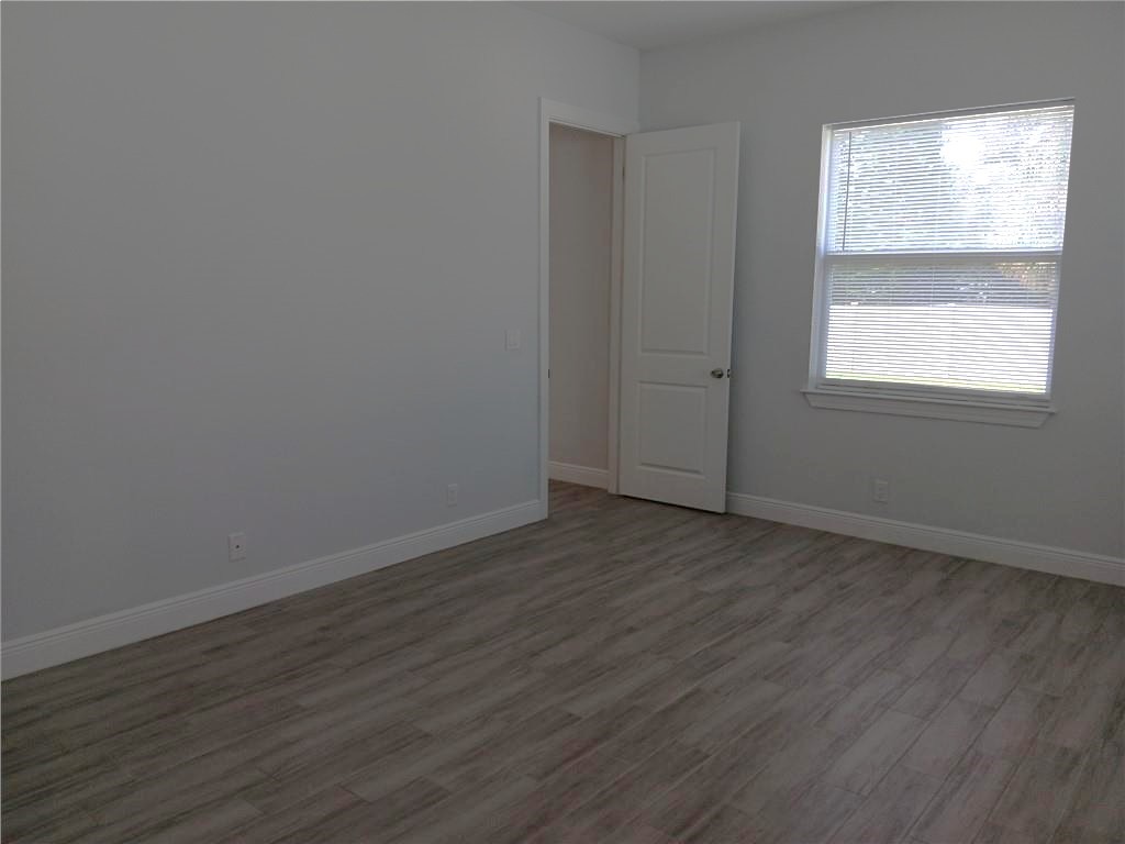 2121 Bridgehampton Terrace Vero Beach, FL 32966 - Photo 14 of 33 an empty room with wooden floor and windows