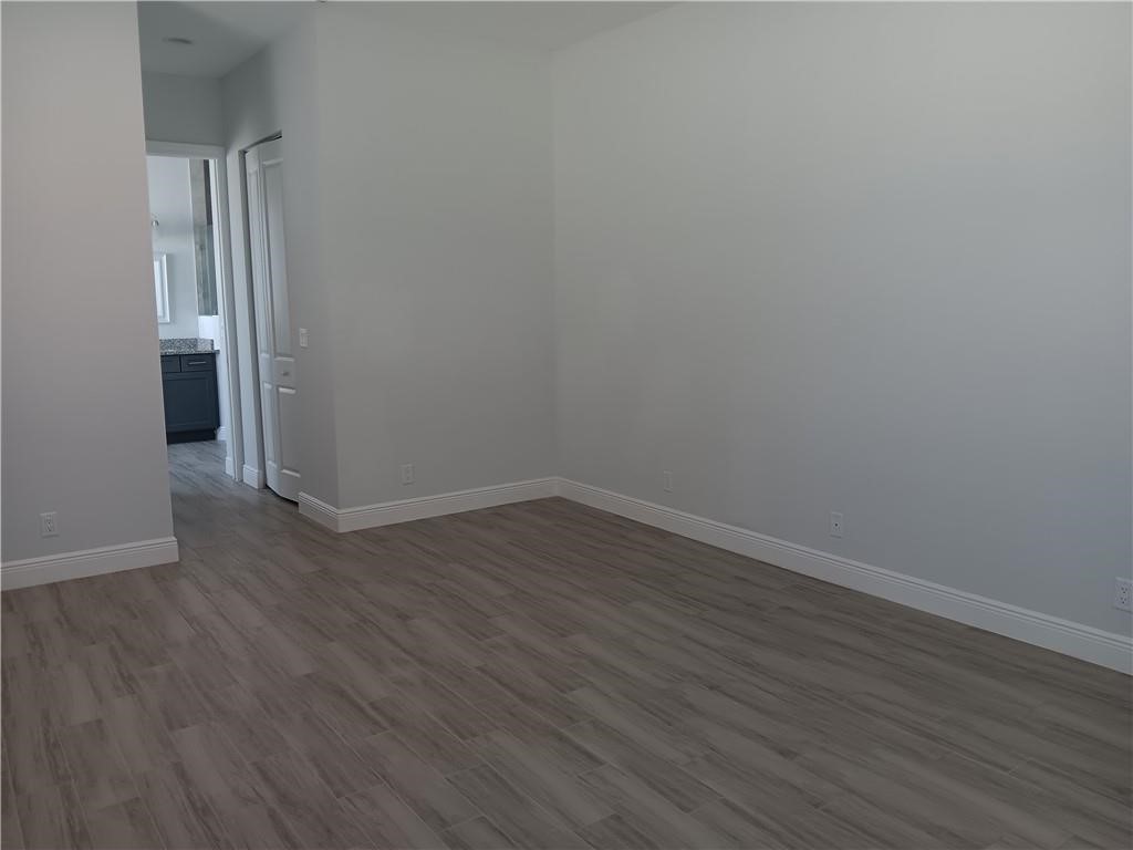 2121 Bridgehampton Terrace Vero Beach, FL 32966 - Photo 15 of 33 an empty room with wooden floor and windows