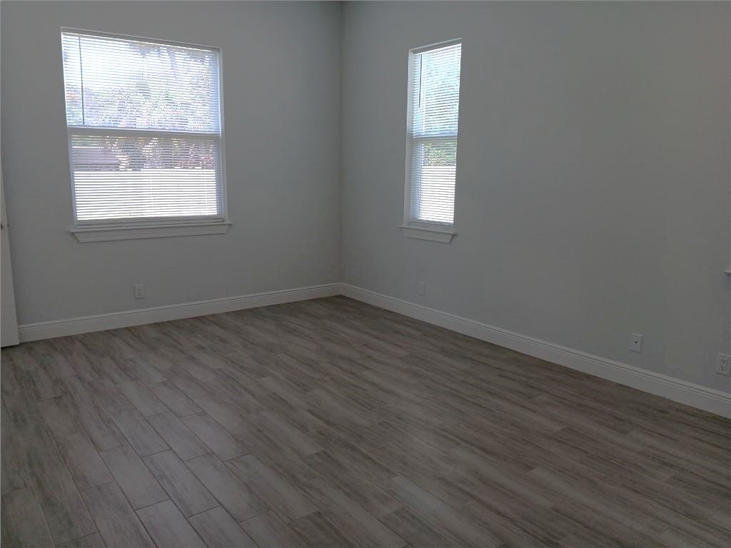 2121 Bridgehampton Terrace Vero Beach, FL 32966 - Photo 16 of 33 an empty room with wooden floor and windows