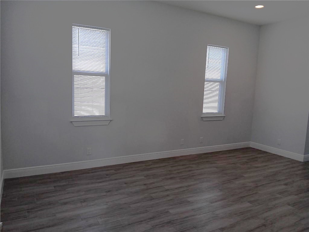 2121 Bridgehampton Terrace Vero Beach, FL 32966 - Photo 17 of 33 an empty room with wooden floor and windows