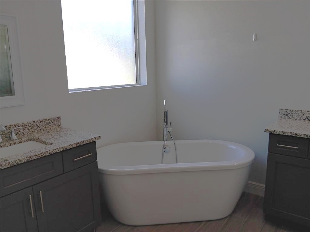 2121 Bridgehampton Terrace Vero Beach, FL 32966 - Photo 18 of 33 a white bath tub sitting in a bathroom
