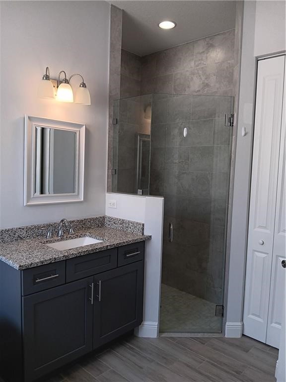 2121 Bridgehampton Terrace Vero Beach, FL 32966 - Photo 19 of 33 a bathroom with a granite countertop sink a mirror and shower