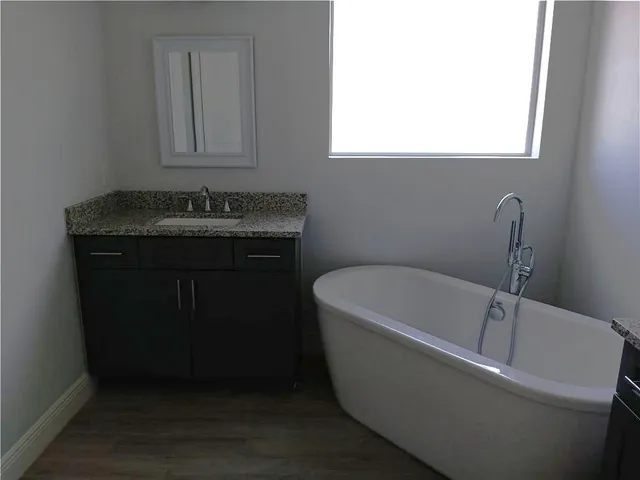 a bathroom with a bathtub and a sink