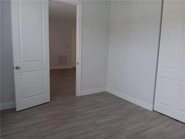 a view of a room with wooden floor