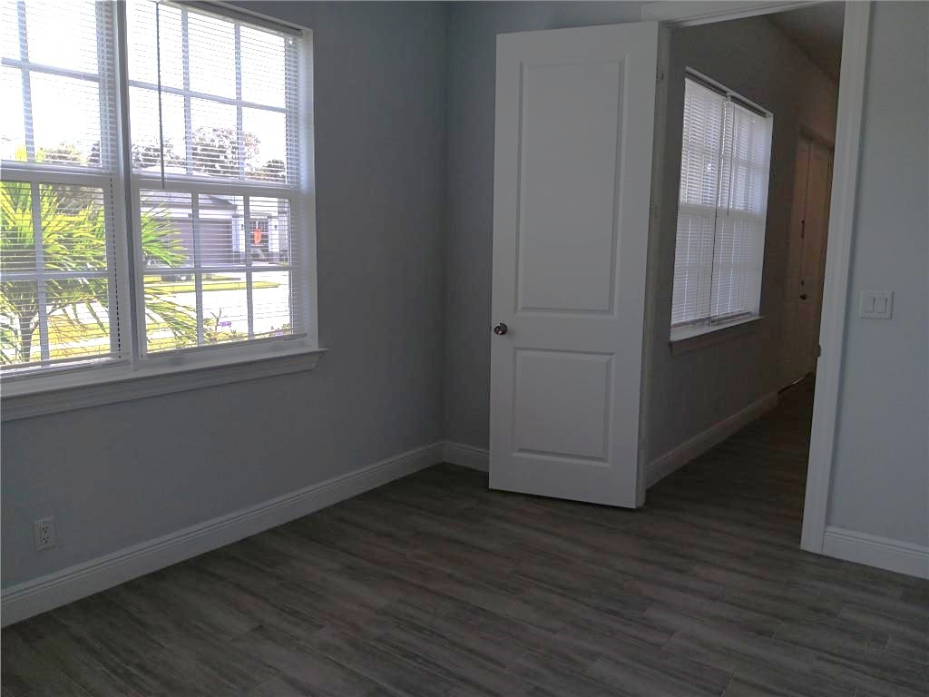 2121 Bridgehampton Terrace Vero Beach, FL 32966 - Photo 25 of 33 an empty room with wooden floor and windows