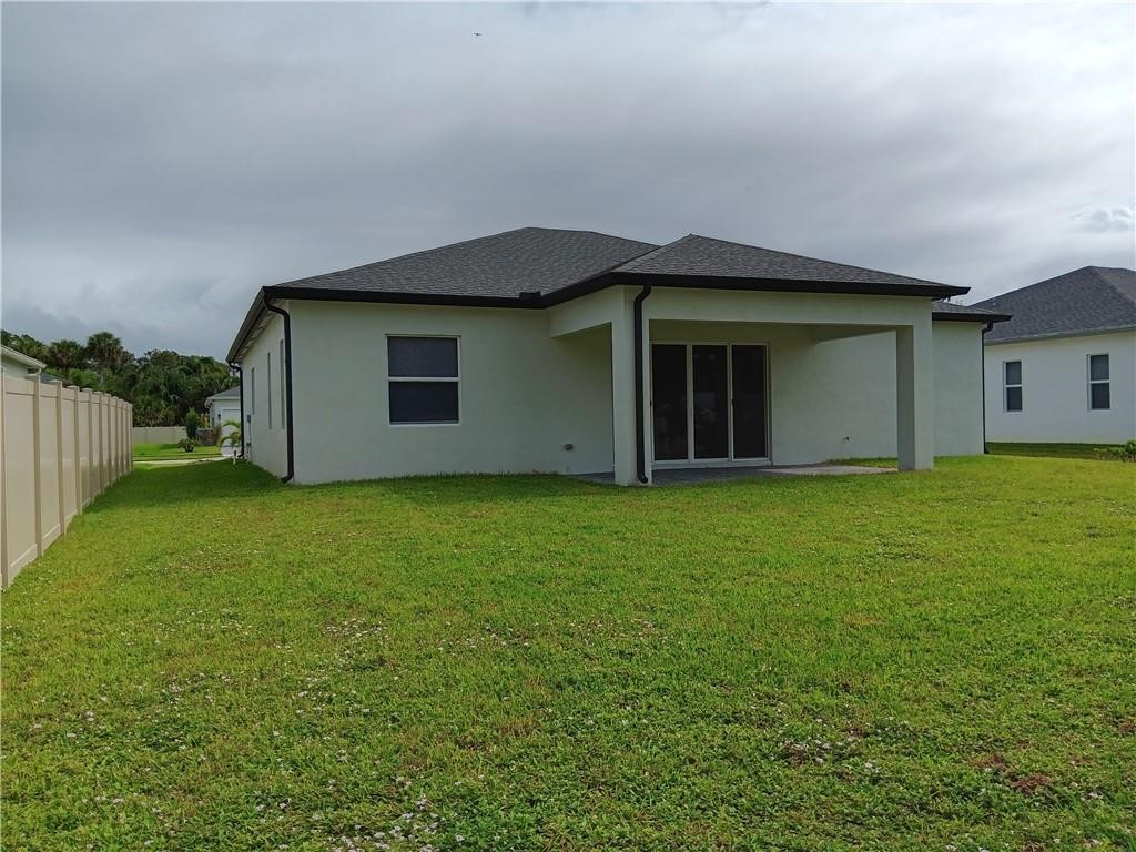 2121 Bridgehampton Terrace Vero Beach, FL 32966 - Photo 32 of 33 a view of a house with a yard