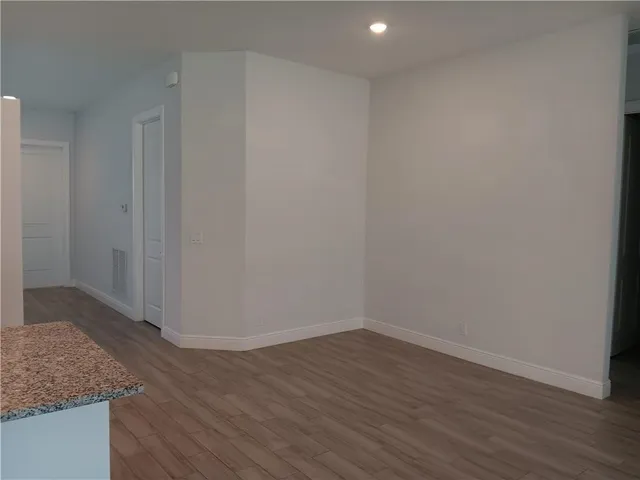 a view of wooden floor and cabinets in a room