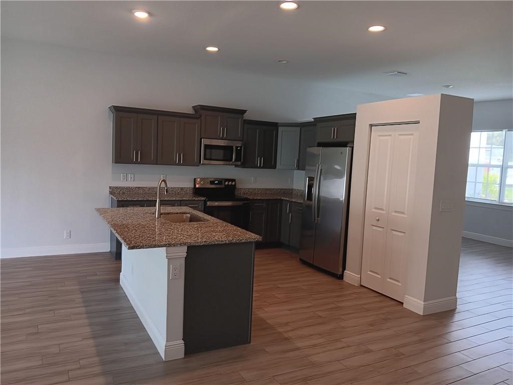 2121 Bridgehampton Terrace Vero Beach, FL 32966 - Photo 10 of 33 a kitchen with kitchen island stainless steel appliances a sink stove and refrigerator