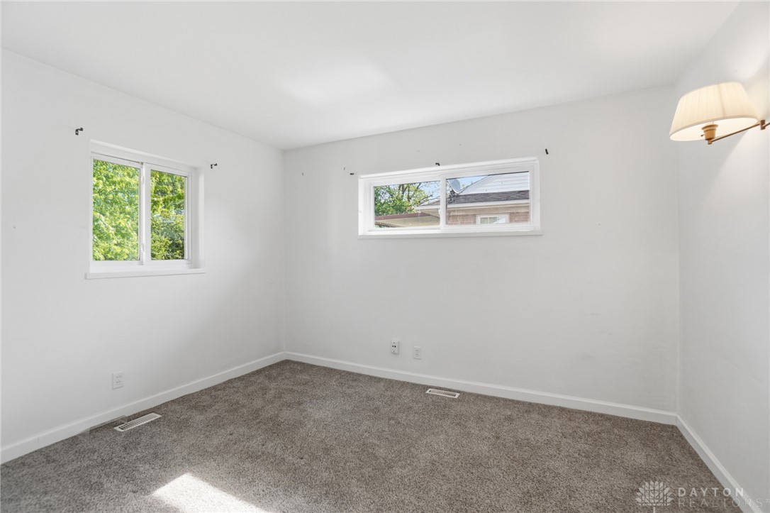 629 Storms Road Dayton, OH 45429 - Photo 29 of 51 This spacious bedroom offers ample natural light and plush carpet for comfort.