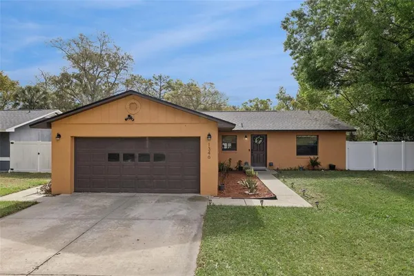 a view of a house with a yard and garage