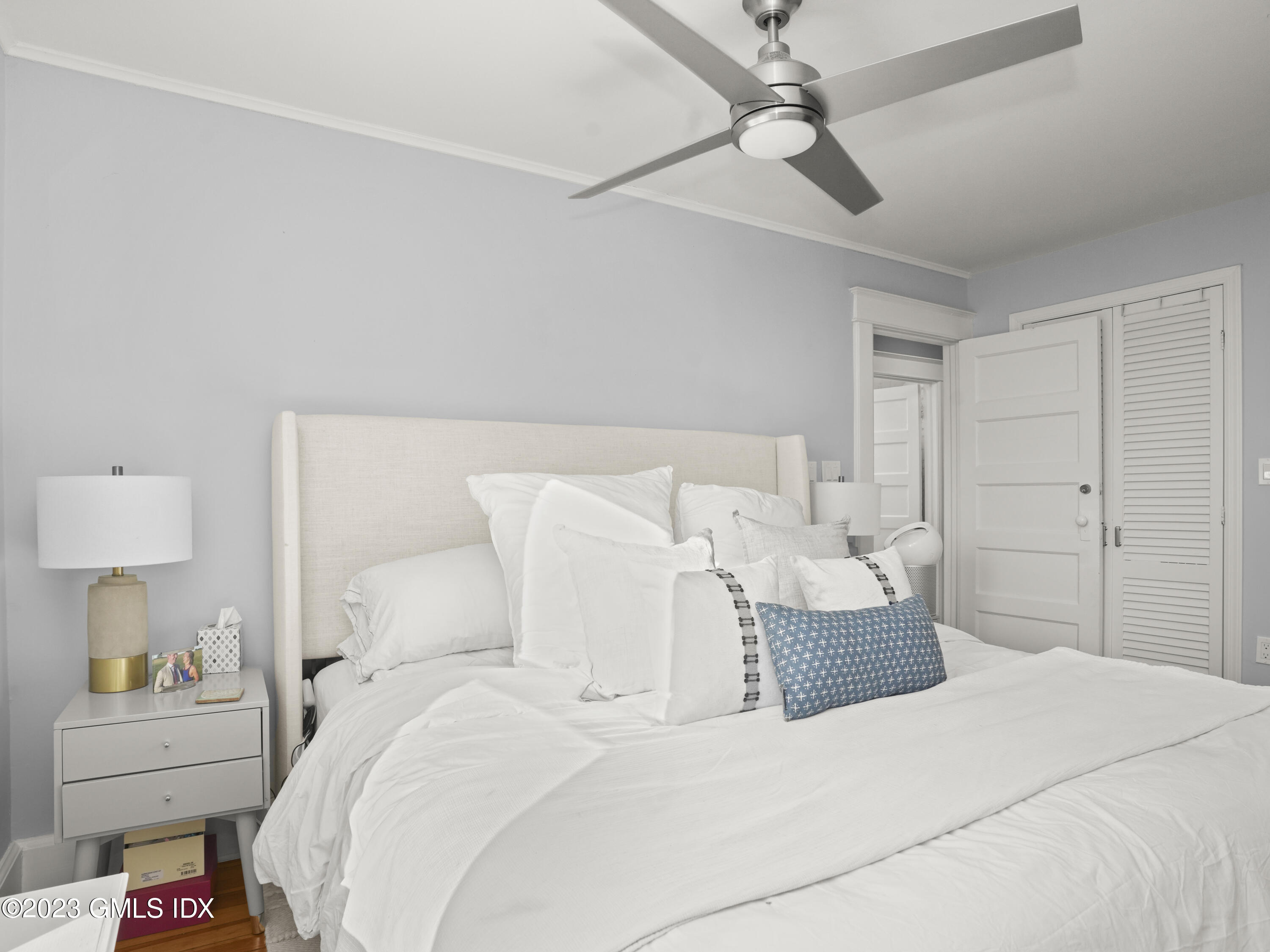 15 Locust Road, Unit COTTAGE Greenwich, CT 06831 - Photo 15 of 25 a bedroom with a bed and a chandelier