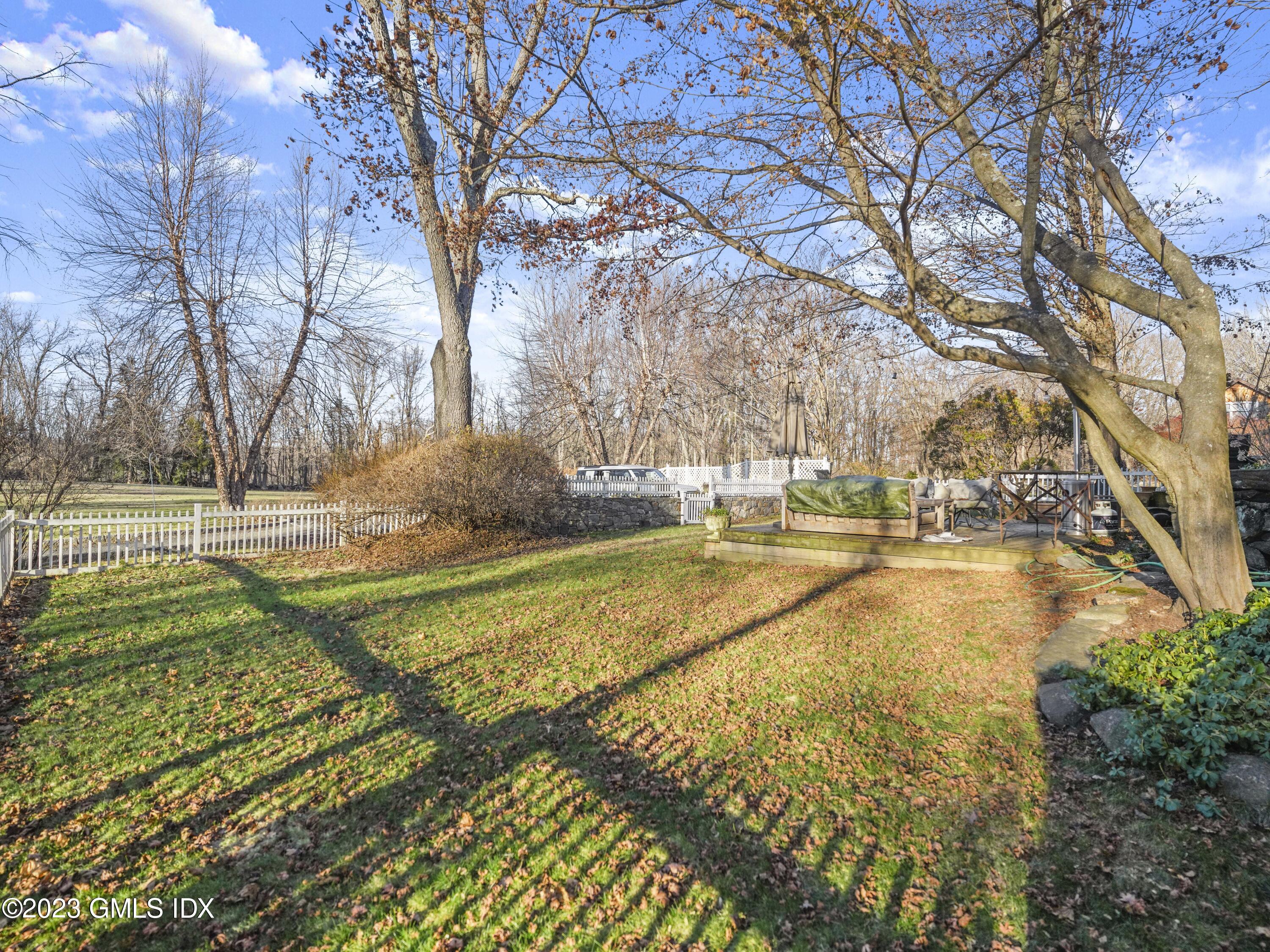 15 Locust Road, Unit COTTAGE Greenwich, CT 06831 - Photo 22 of 25 a view of residential houses with yard and swimming pool