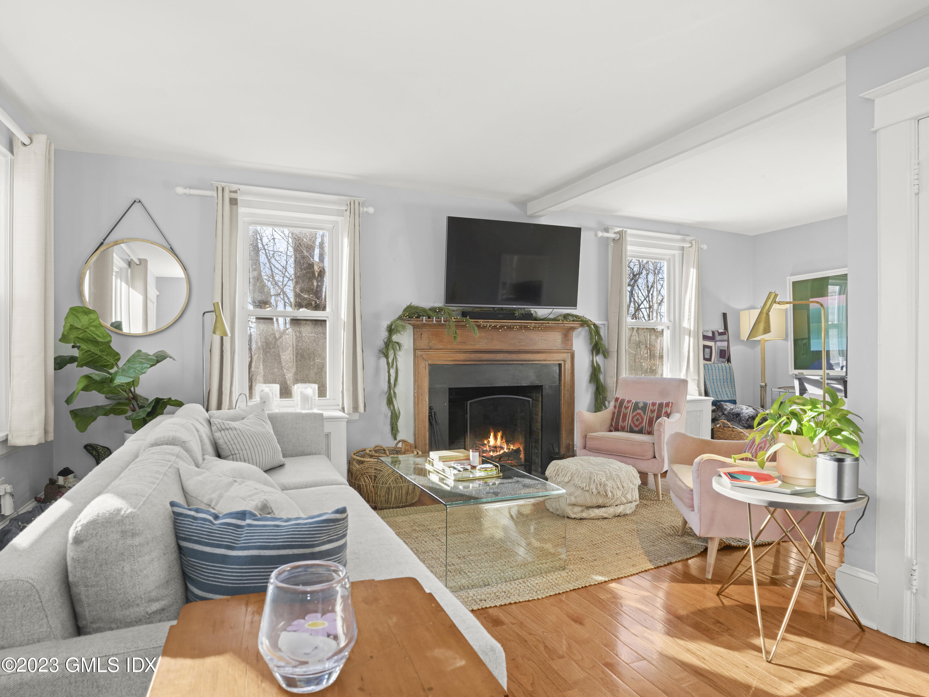 15 Locust Road, Unit COTTAGE Greenwich, CT 06831 - Photo 4 of 25 a living room with furniture a fireplace and a flat screen tv