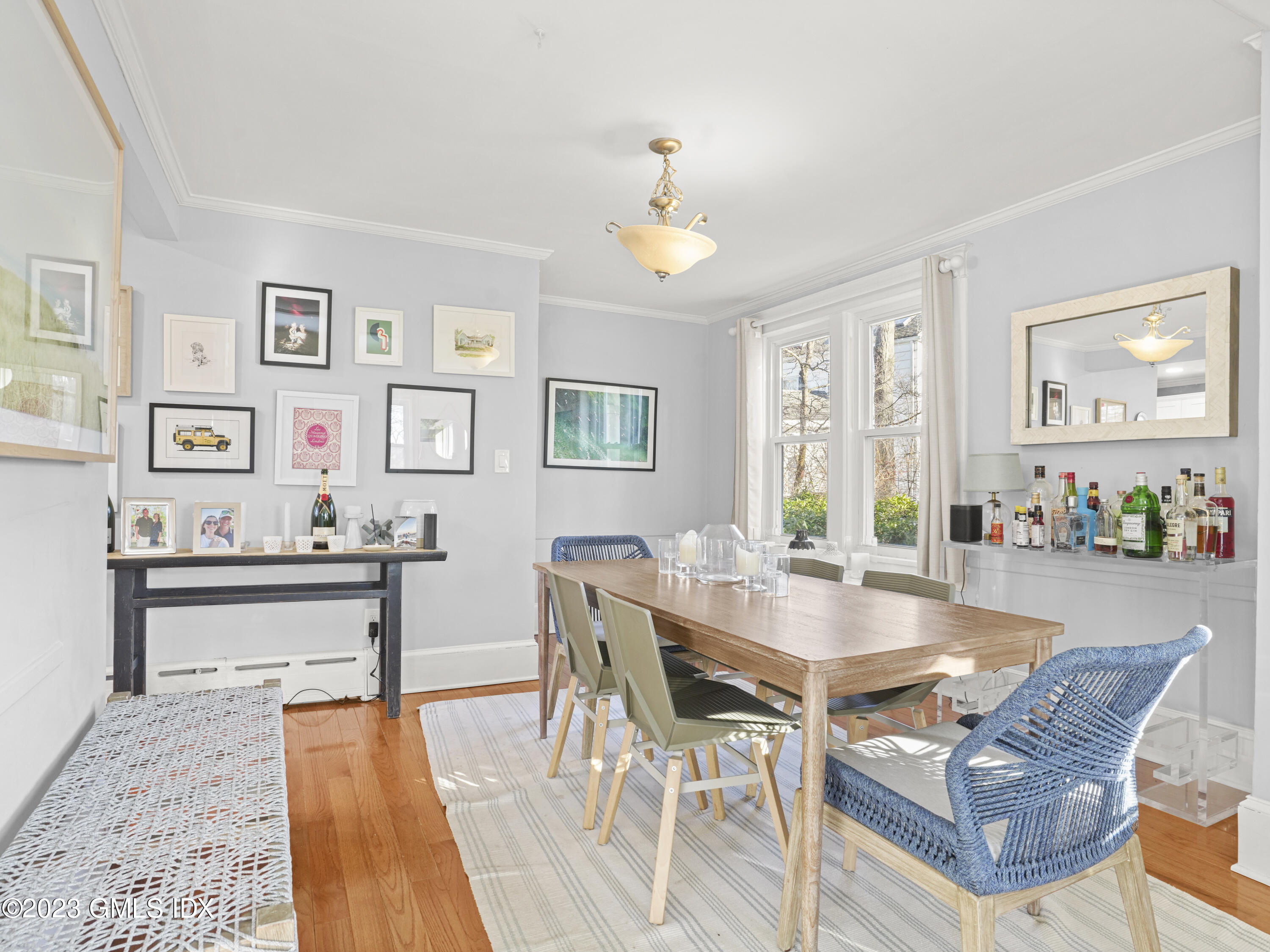 15 Locust Road, Unit COTTAGE Greenwich, CT 06831 - Photo 5 of 25 a view of a dining room with furniture window and wooden floor