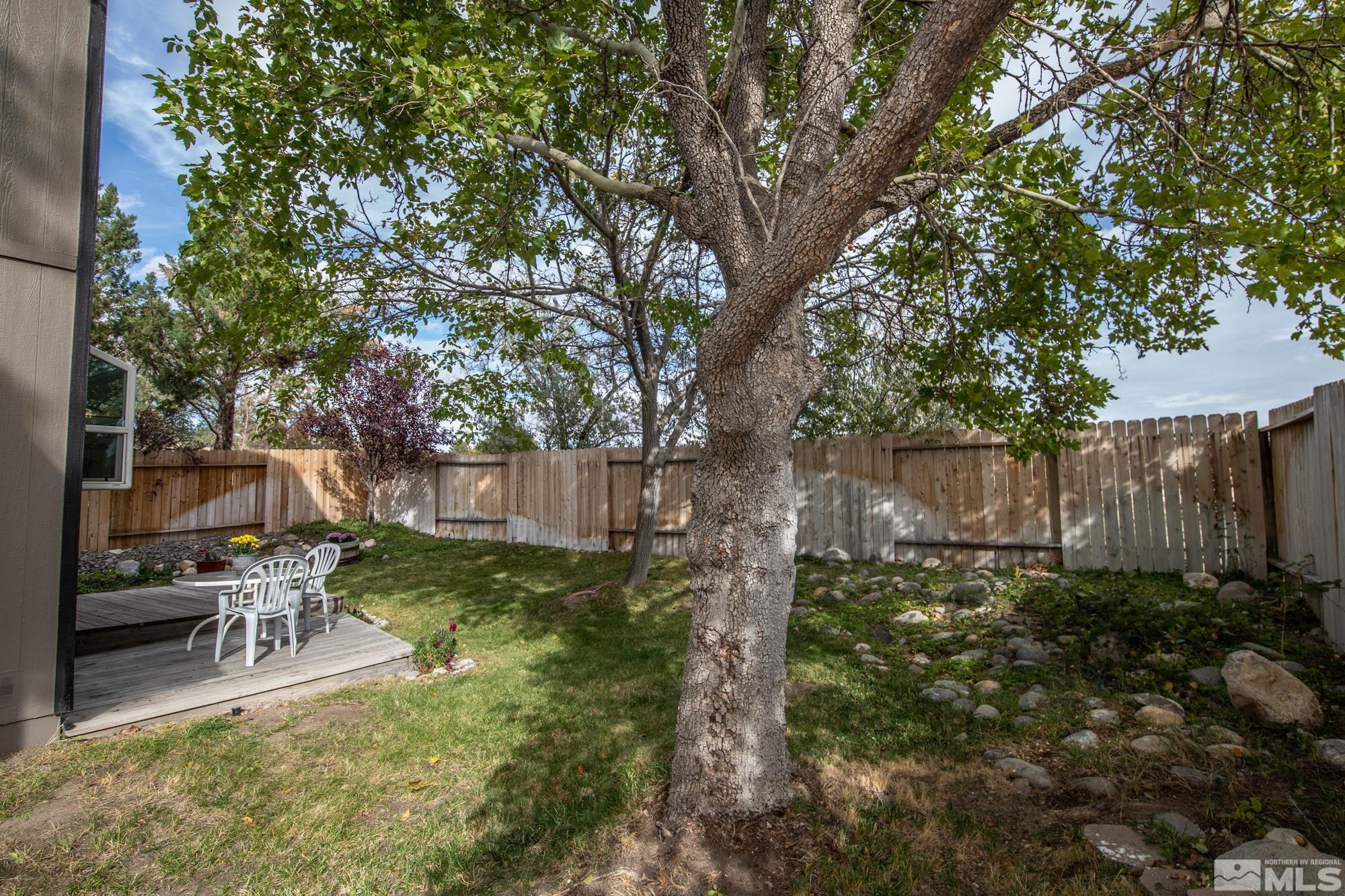 5861 Bankside Way Reno, NV 89523 - Photo 32 of 39 a backyard of a house with table and chairs