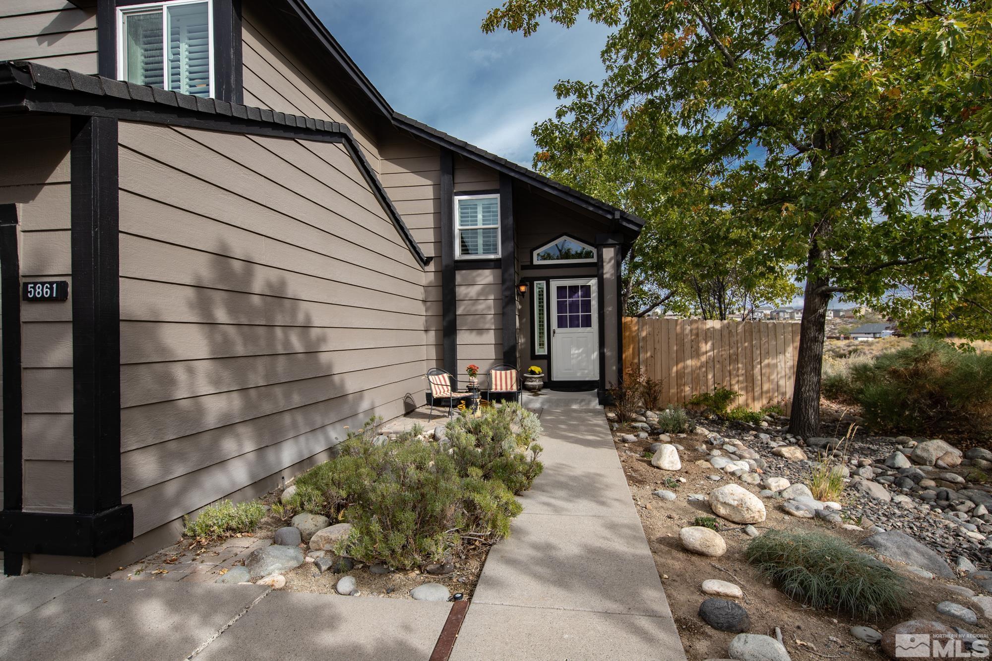 5861 Bankside Way Reno, NV 89523 - Photo 38 of 39 a backyard of a house with large trees and outdoor seating