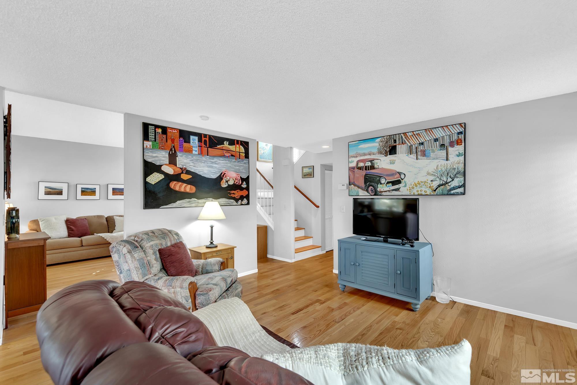 5861 Bankside Way Reno, NV 89523 - Photo 9 of 39 a living room with furniture and a flat screen tv