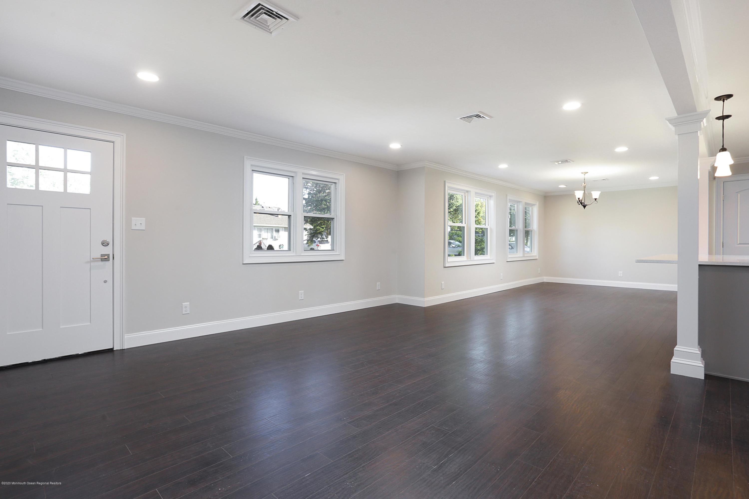 715 Pine Drive Brick, NJ 08723 - Photo 13 of 41 an empty room with wooden floor and windows