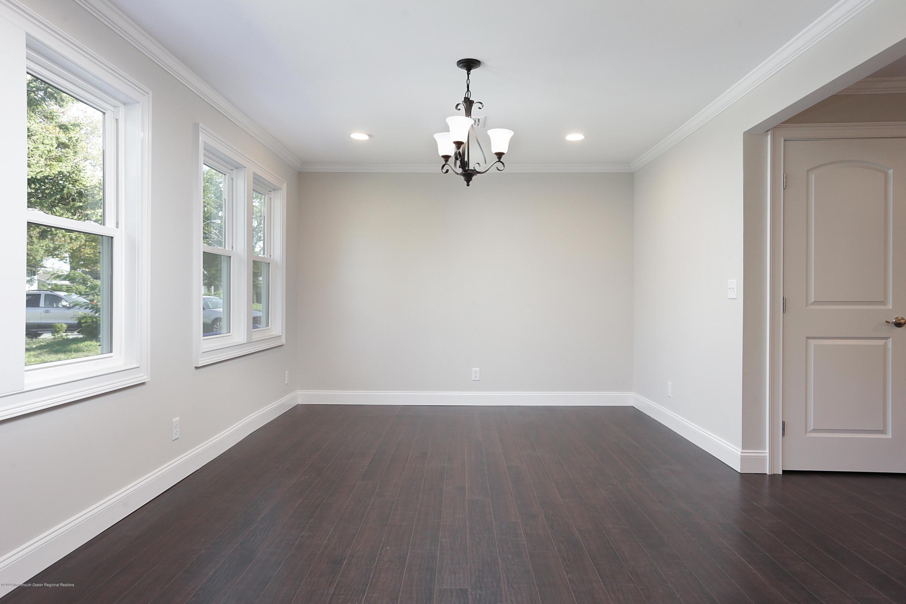 715 Pine Drive Brick, NJ 08723 - Photo 15 of 41 a view of an empty room with wooden floor and a window