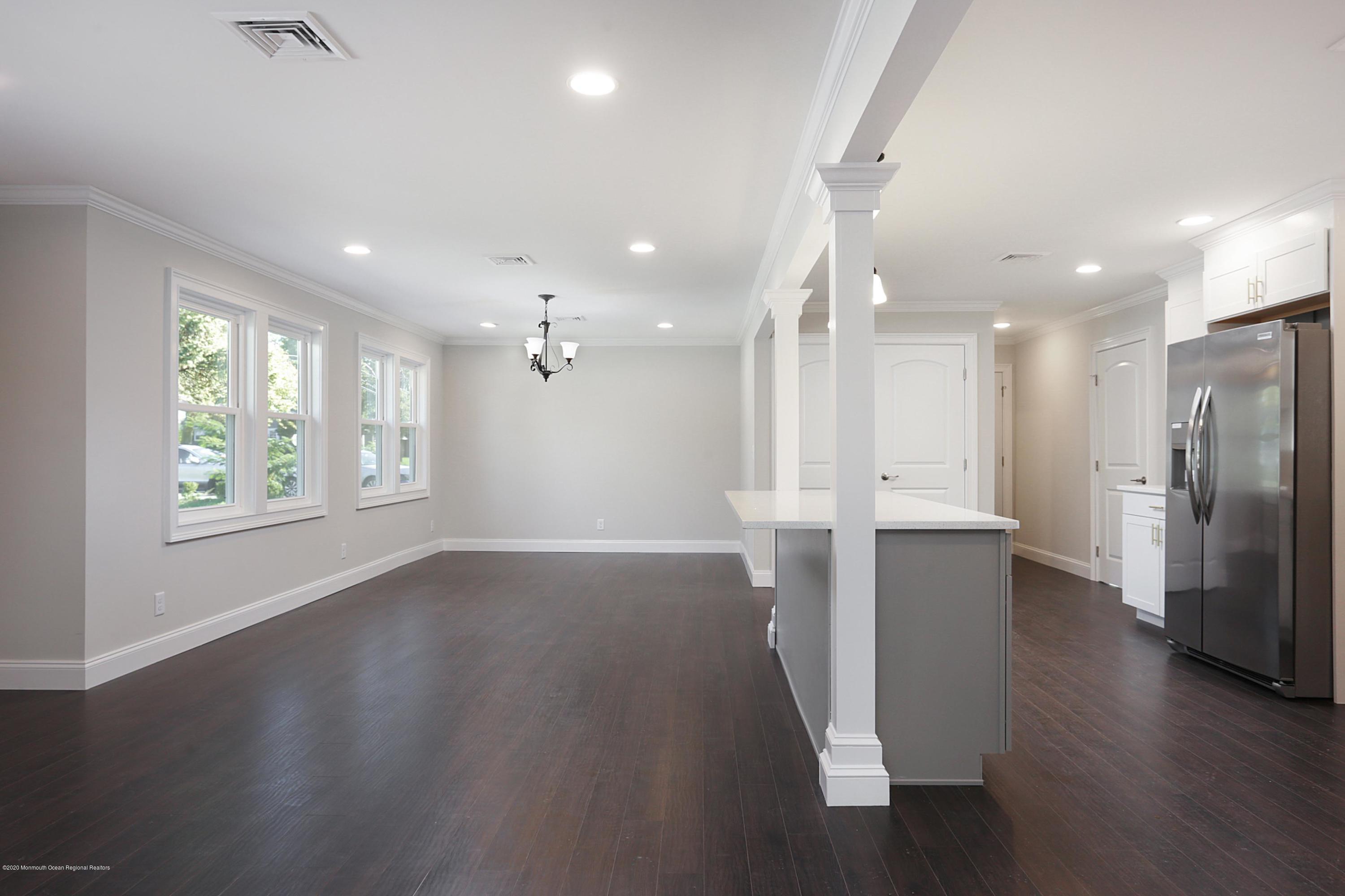 715 Pine Drive Brick, NJ 08723 - Photo 17 of 41 an empty room with wooden floor and windows