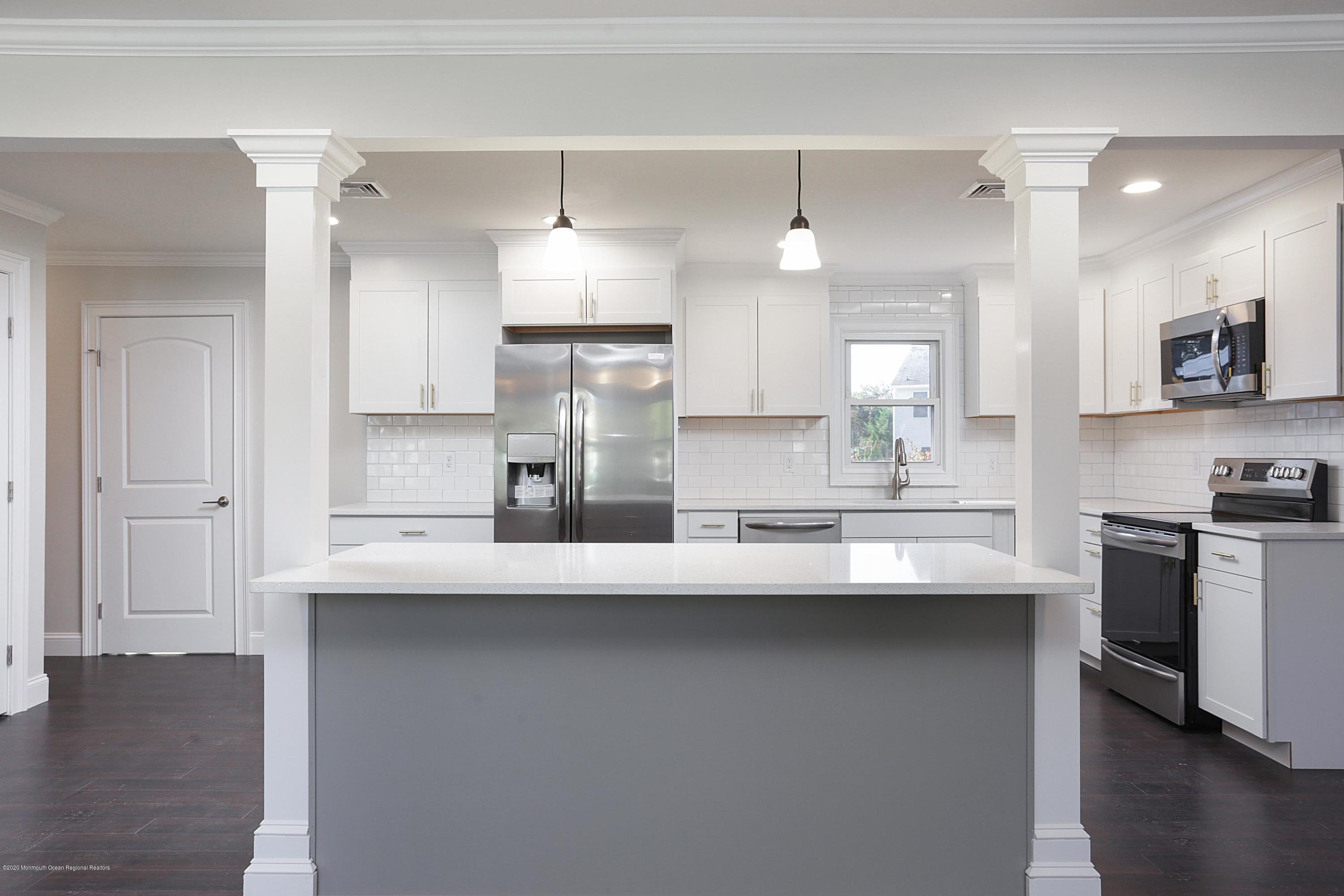 715 Pine Drive Brick, NJ 08723 - Photo 18 of 41 a kitchen with refrigerator and cabinets