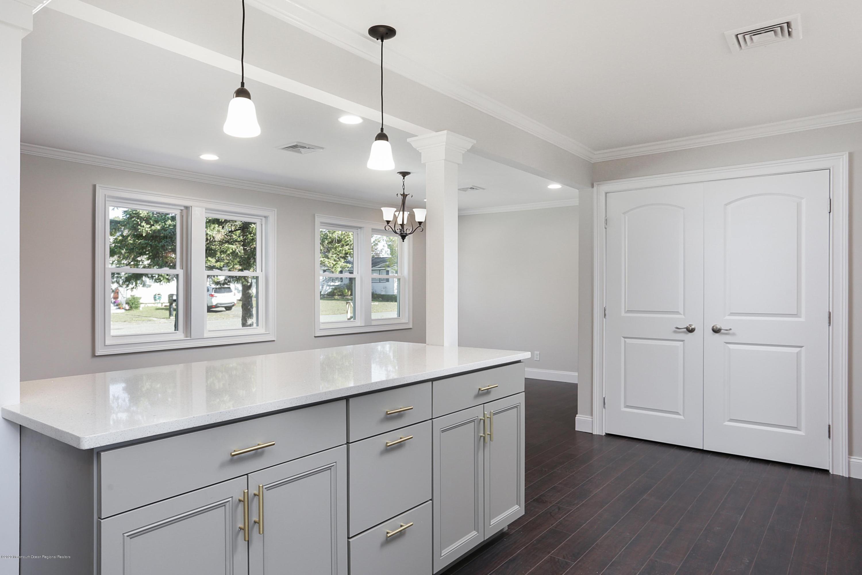 715 Pine Drive Brick, NJ 08723 - Photo 19 of 41 a kitchen with a sink a window and wooden floor