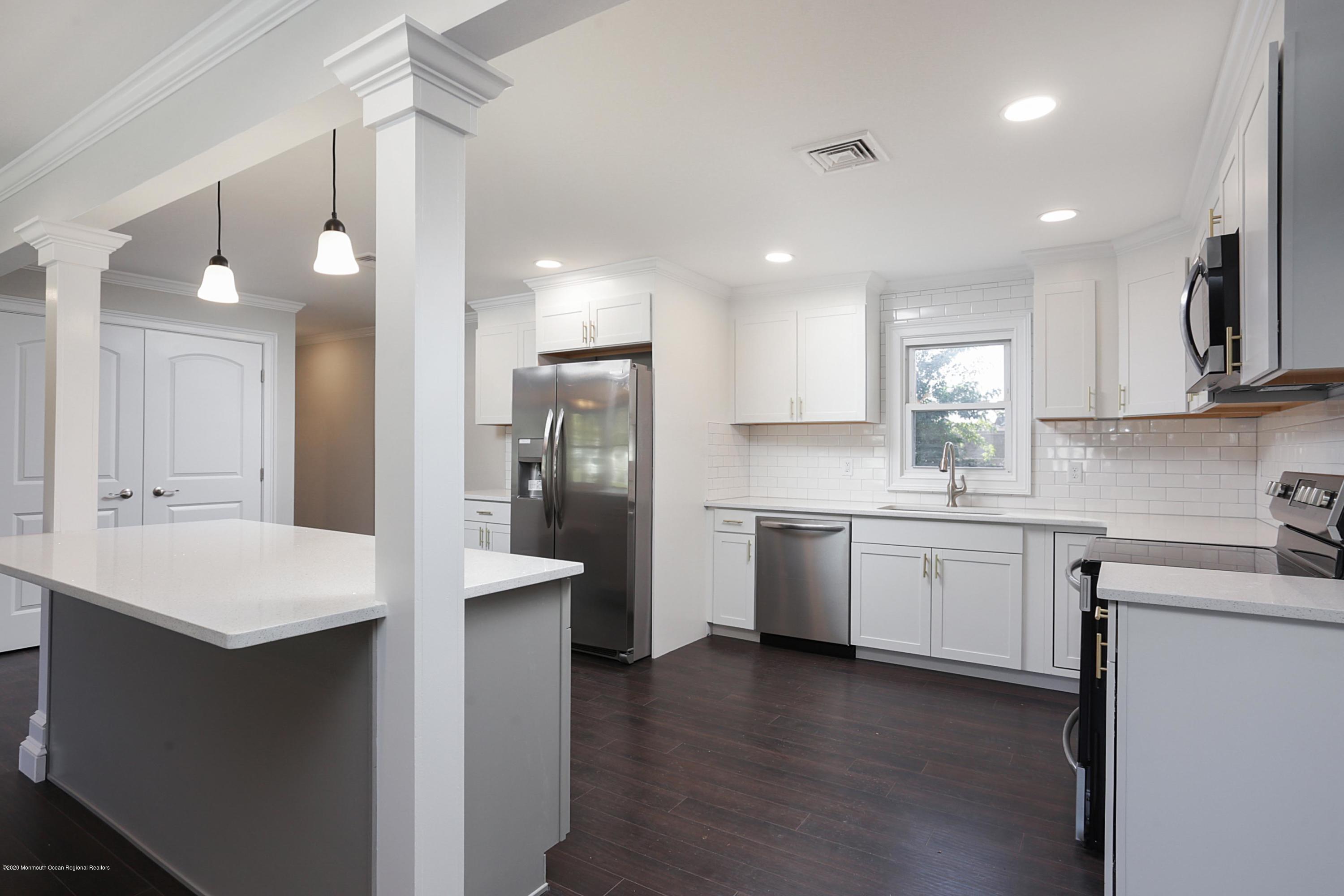 715 Pine Drive Brick, NJ 08723 - Photo 20 of 41 a large kitchen with stainless steel appliances kitchen island granite countertop a sink refrigerator and cabinets