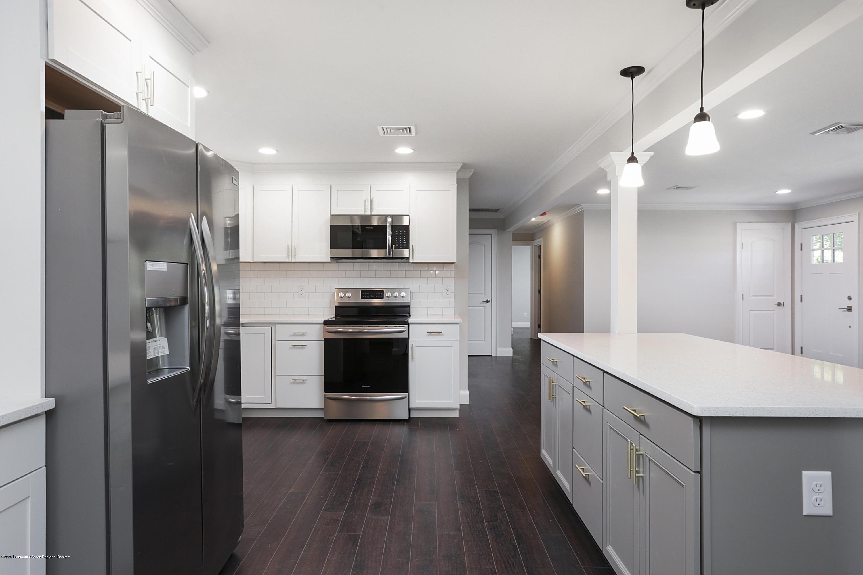 715 Pine Drive Brick, NJ 08723 - Photo 23 of 41 a kitchen with stainless steel appliances a refrigerator sink and microwave