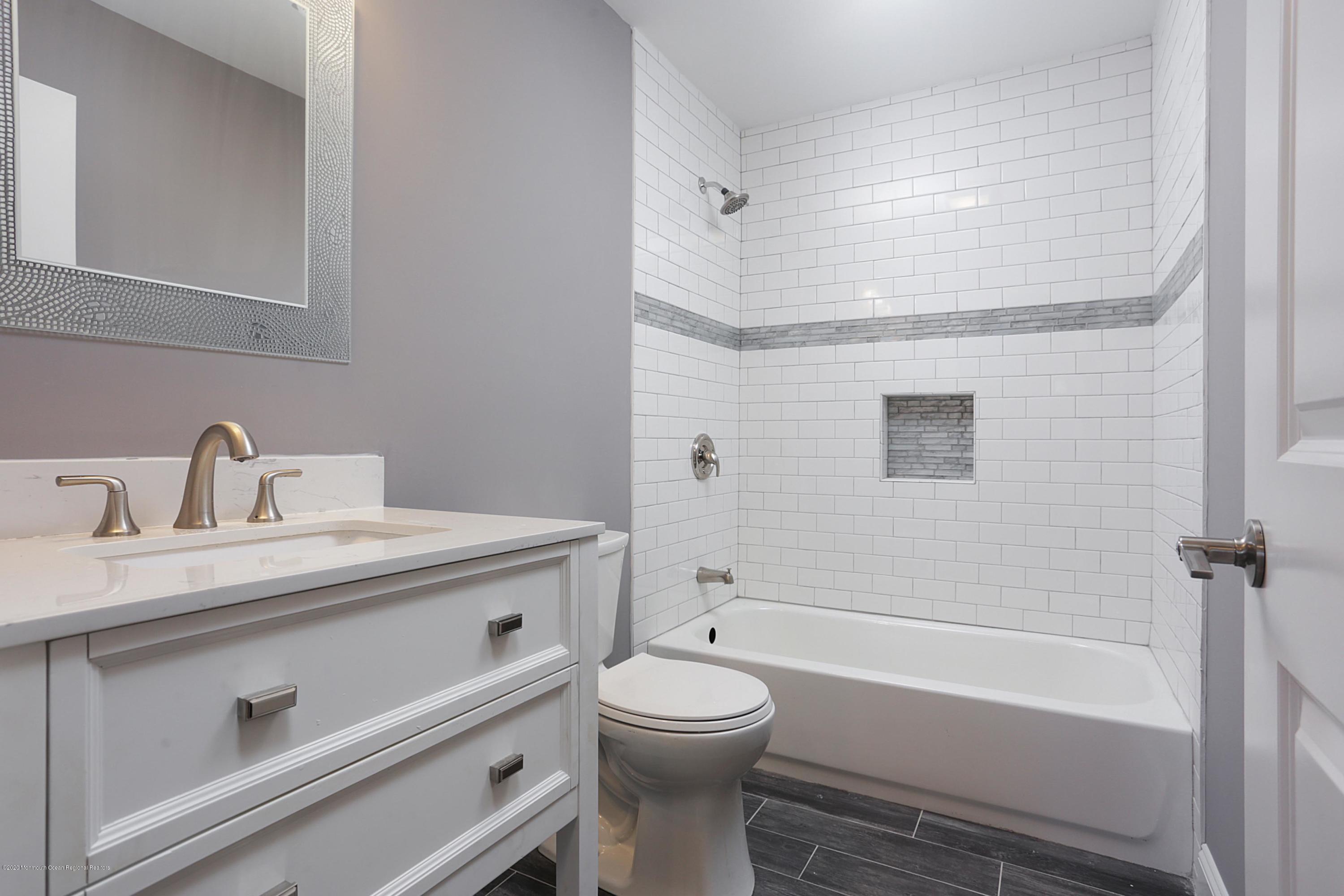 715 Pine Drive Brick, NJ 08723 - Photo 25 of 41 a bathroom with a sink a toilet and a bathtub
