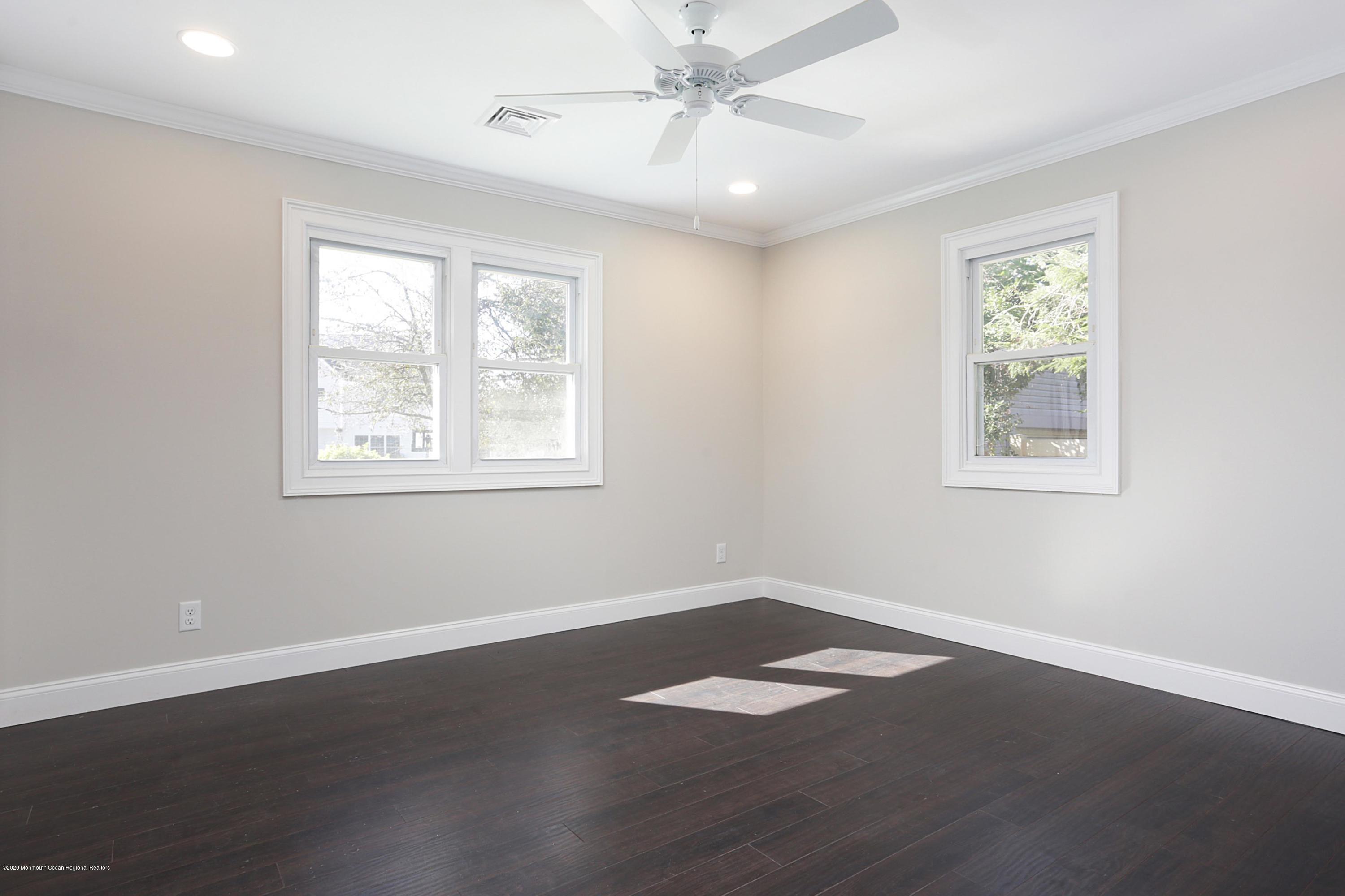 715 Pine Drive Brick, NJ 08723 - Photo 26 of 41 a view of an empty room with wooden floor and a window