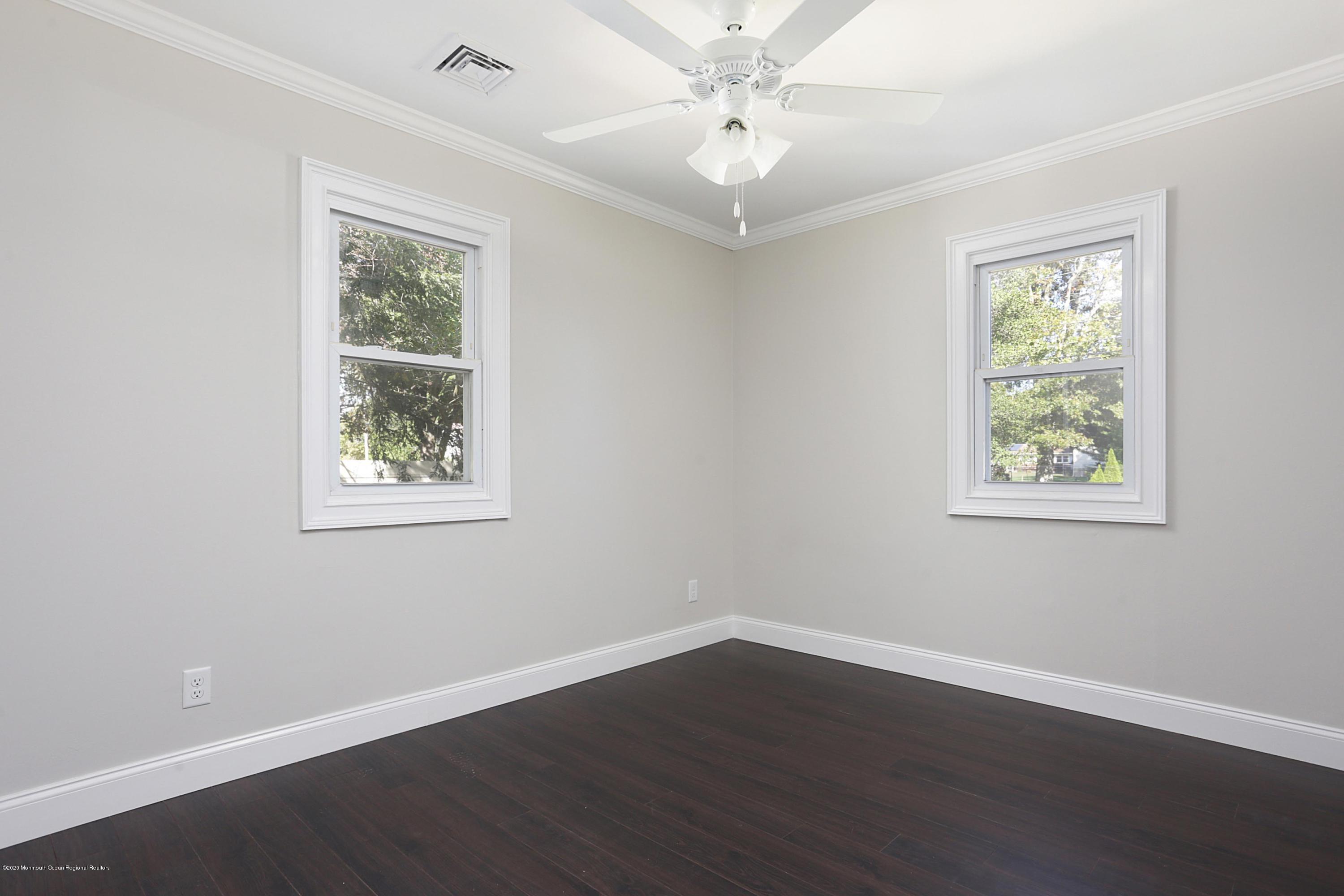 715 Pine Drive Brick, NJ 08723 - Photo 30 of 41 a view of an empty room with wooden floor and a window