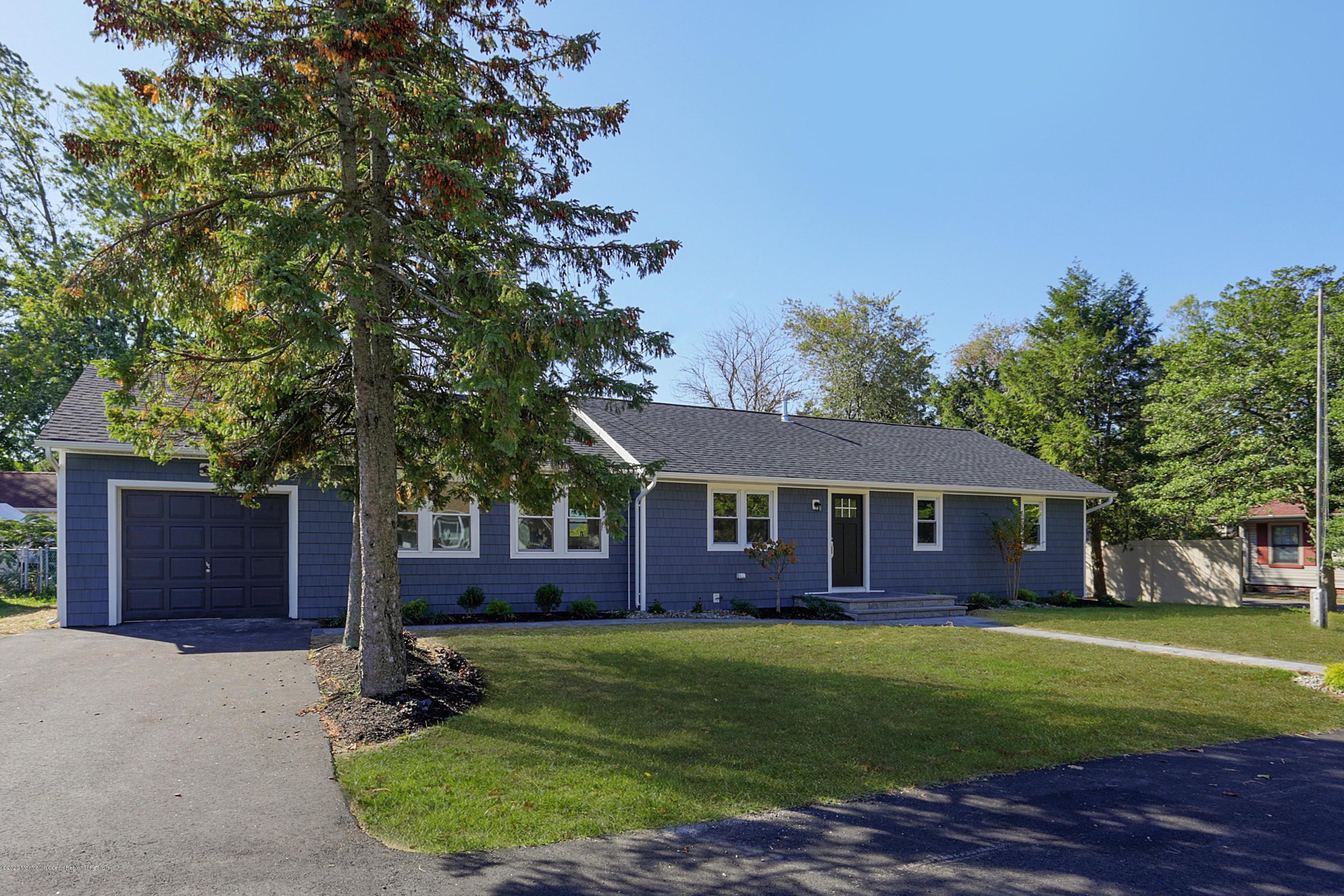 715 Pine Drive Brick, NJ 08723 - Photo 37 of 41 a front view of a house with a garden and trees