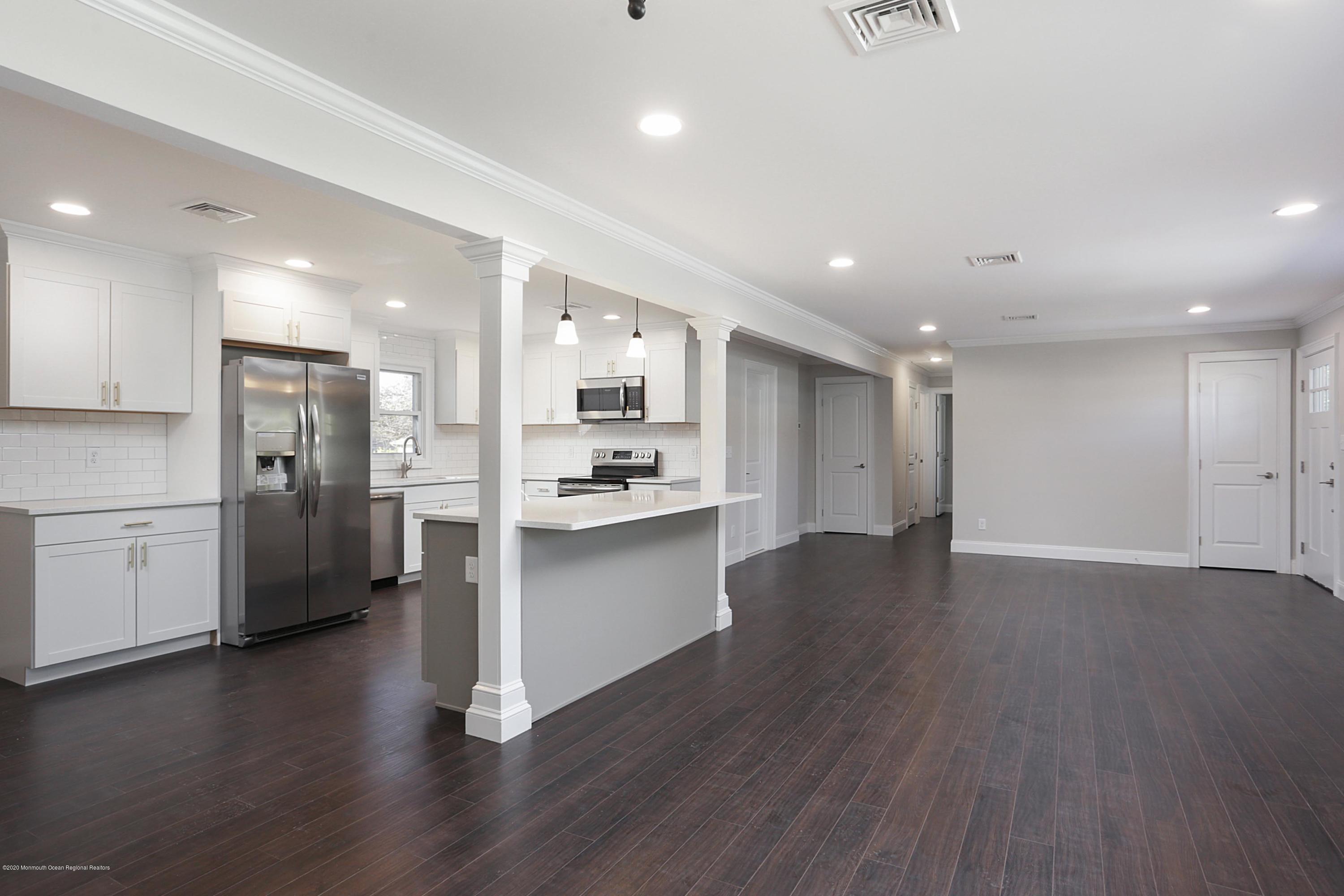 715 Pine Drive Brick, NJ 08723 - Photo 9 of 41 a view of kitchen with refrigerator stove and wooden floor