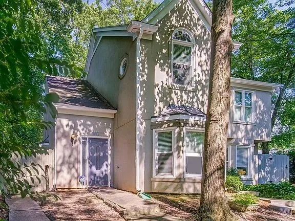 front view of a house with a tree