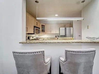 a bathroom with a sink mirror and tub
