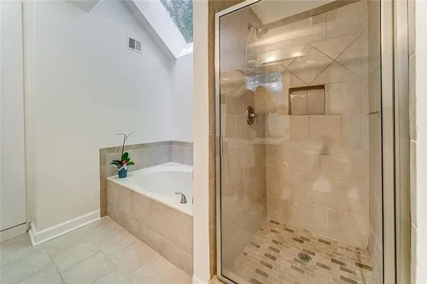 a bathroom with a bathtub and shower