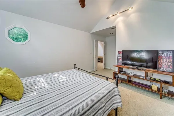 a bedroom with bed and flat screen tv