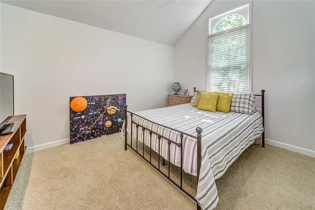 a bed sitting in a bedroom next to a window