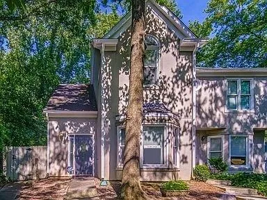 a front view of a building with a garden