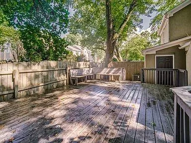 a view of backyard with a deck and wooden floor