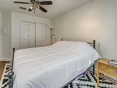 a bedroom with a bed and a chandelier