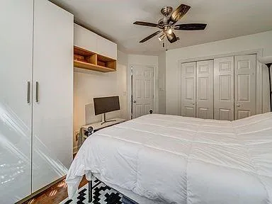 a bedroom with a bed and a chandelier