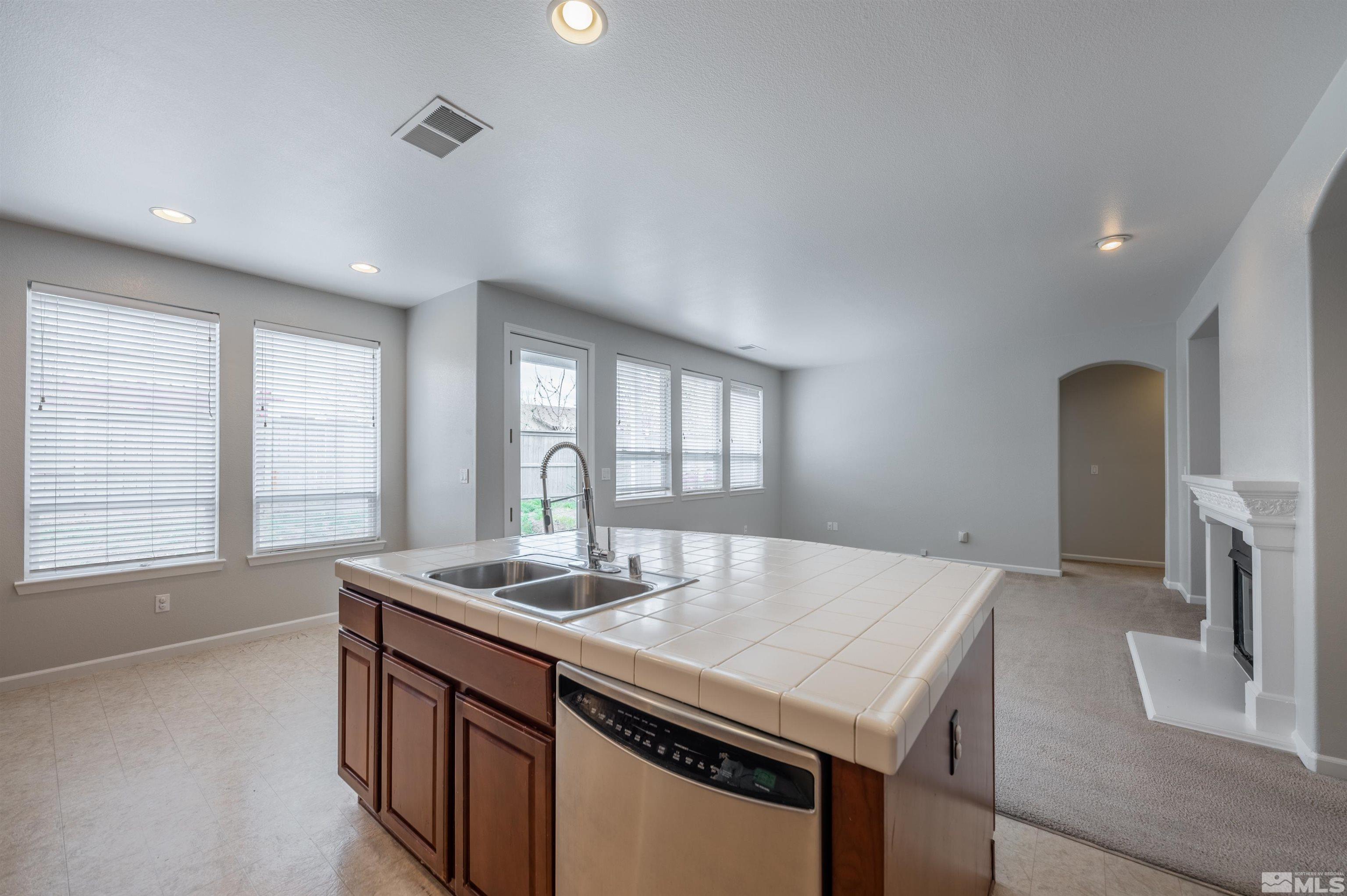 435 Haleb Court Reno, NV 89521 - Photo 8 of 30 a kitchen with a stove a sink and a refrigerator