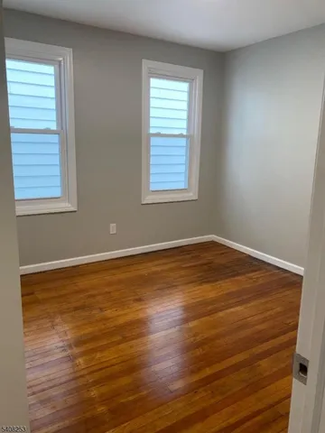 a view of a room with wooden floor and window