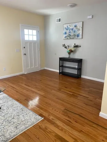 a view of a room with wooden floor and cabinet