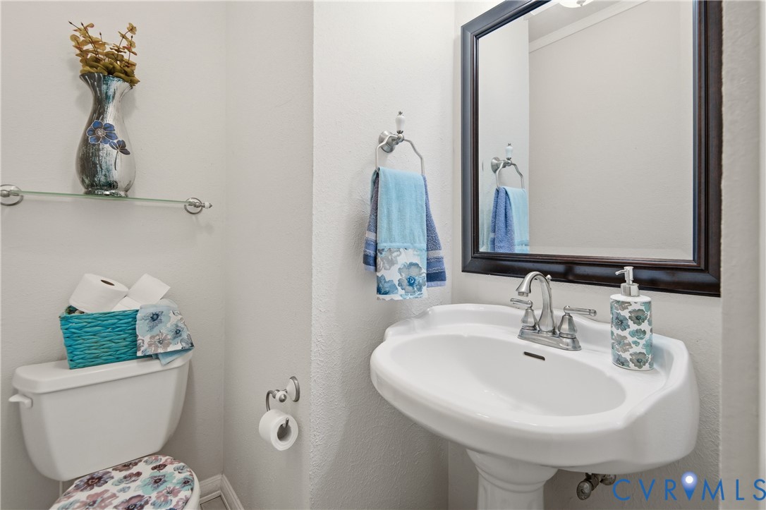 107 Oxford Road Hopewell, VA 23860 - Photo 27 of 50 Pedestal sink with chrome faucet, framed mirror, a