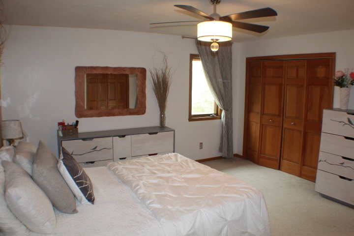 4241 Gloucester Road Roscoe, IL 61073 - Photo 13 of 50 a bedroom with a bed and a chandelier