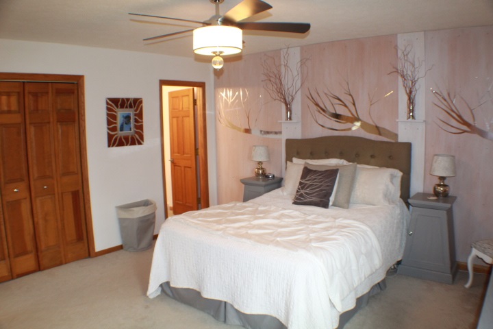 4241 Gloucester Road Roscoe, IL 61073 - Photo 14 of 50 a bedroom with a bed and a chandelier