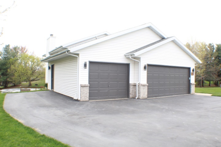 4241 Gloucester Road Roscoe, IL 61073 - Photo 2 of 50 a view of house with garage and large window