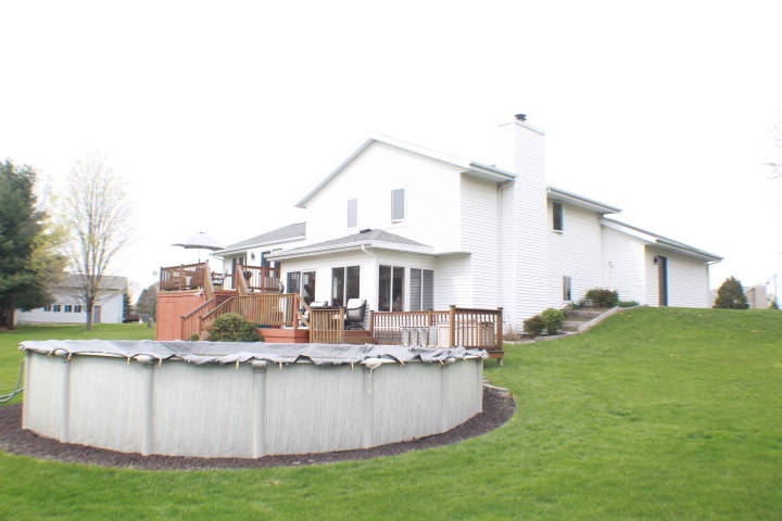4241 Gloucester Road Roscoe, IL 61073 - Photo 40 of 50 a front view of a house with a yard table and chairs